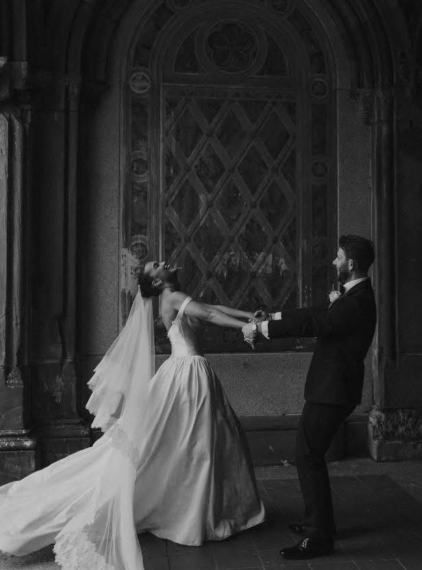 Couple dancing in a stone arcade on their wedding day